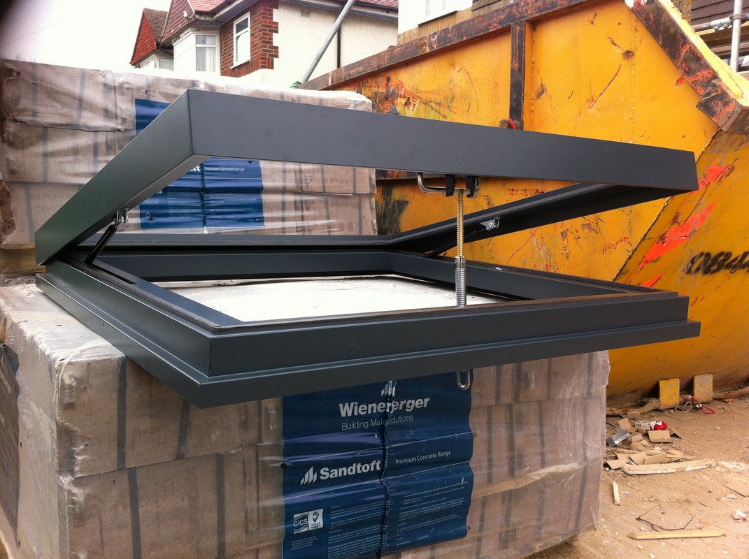 Opening flat roof skylight in anthracite grey installed in Northwood